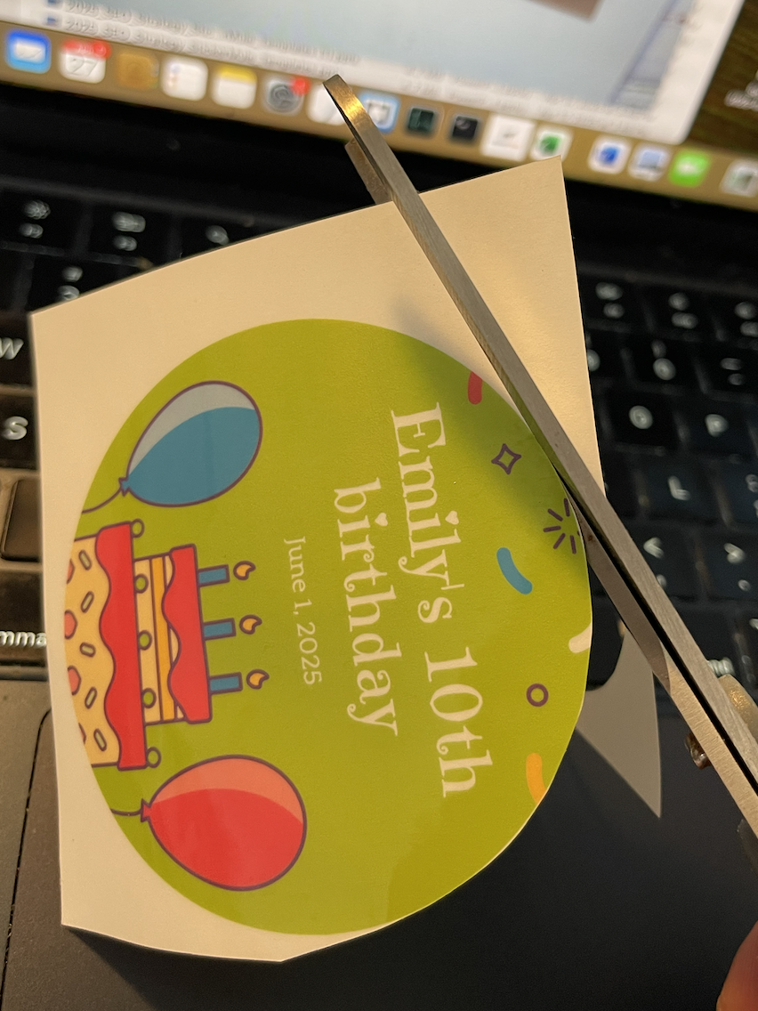 cutting homemade stickers with a scissors