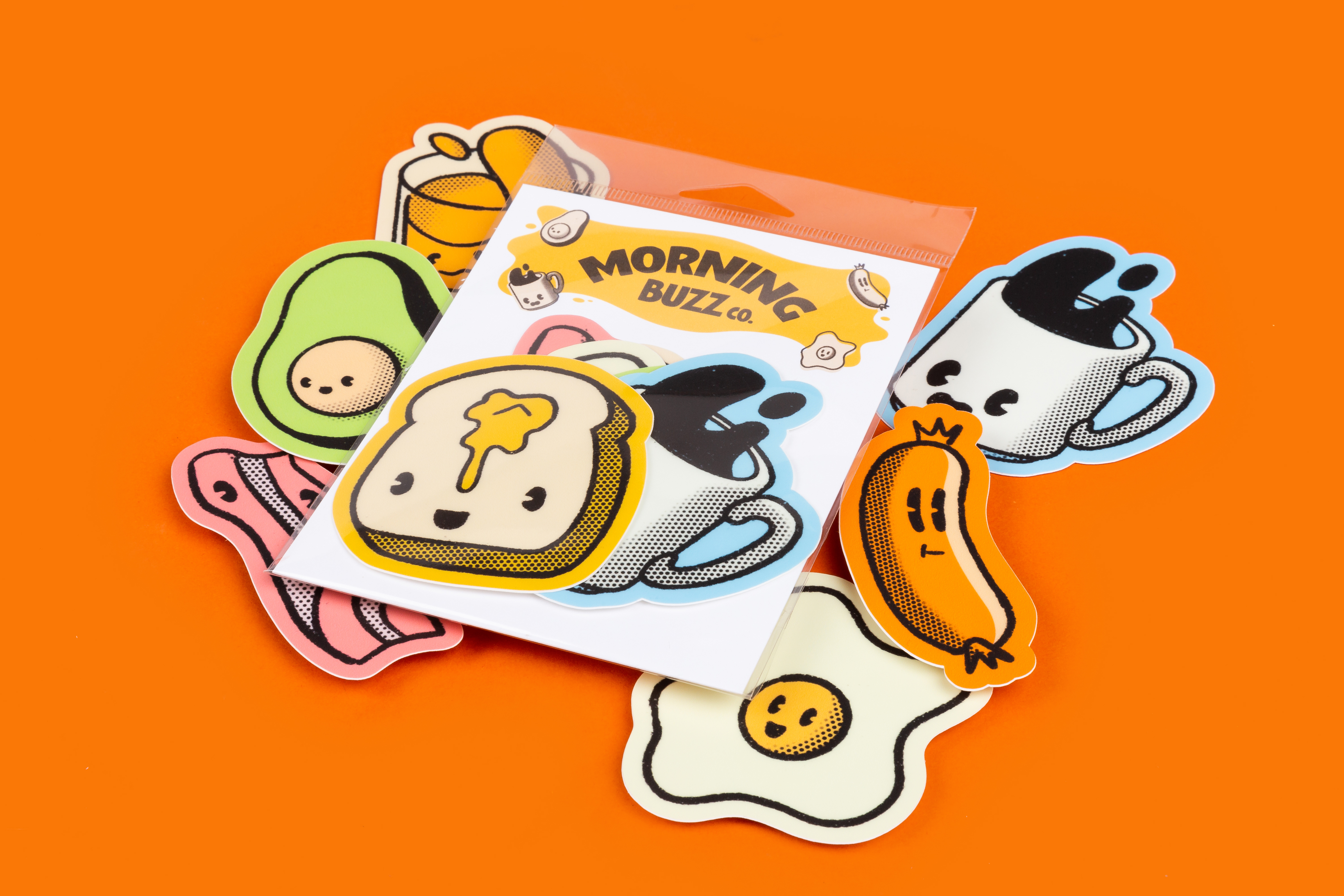 a pack of various stickers shaped like breakfast foods on an orange. background