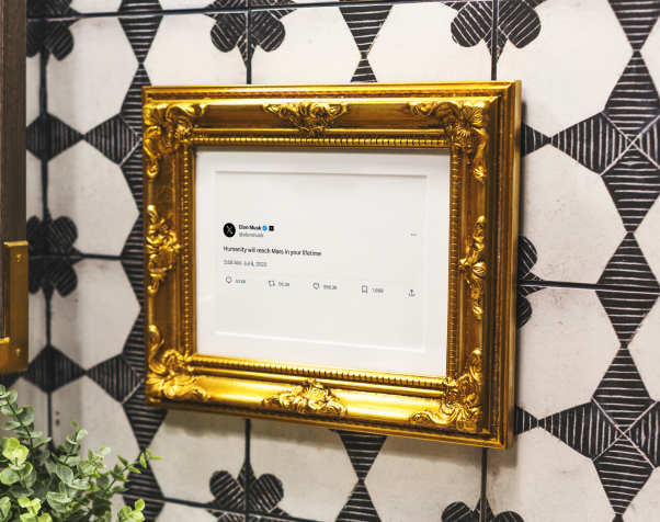 Framed post in gold frame on shelf